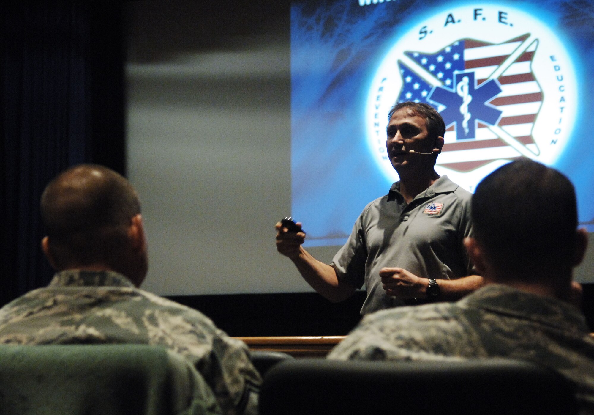 Paramedic Vince Easevoli (right) explains the consequences of distracted driving decisions to Airmen during the Street Smart presentation at the Langley Air Force Base, Va. theater, Nov. 8, 2012.  According to Easevoli, the Street Smart approach is different than other safety briefings in that it explains what actually happens during a crash, and what steps the paramedics must take to save people’s lives.  (U.S. Air Force photo by Staff Sgt. Katie G. Ward/Released)