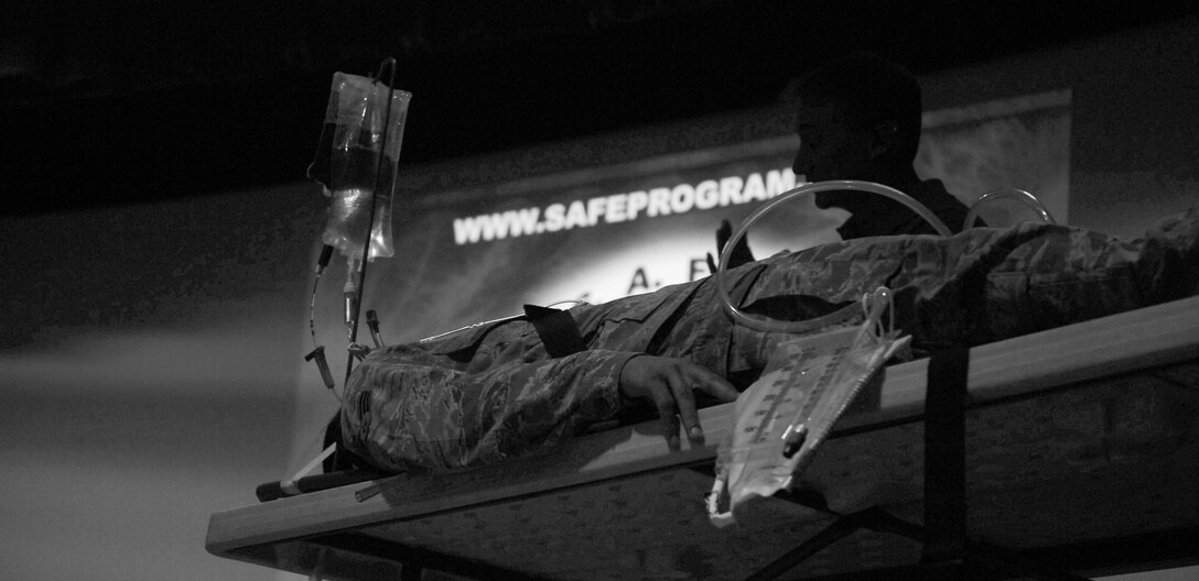 Paramedic Vince Easevoli (right) simulates life-saving procedures on Senior Airman Braxton Ward, 480th Intelligence, Surveillance and Reconnaissance Wing Knowledge operations specialist (left) during the Street Smart presentation at the Langley Air Force Base, Va. theater, Nov. 8, 2012.  In 1988, Easevoli founded Stay Alive From Education, or S.A.F.E, which presents the Street Smart program in hopes to educate people on the consequences of poor driving decisions.  (U.S. Air Force photo illustration by Staff Sgt. Katie G. Ward/Released)