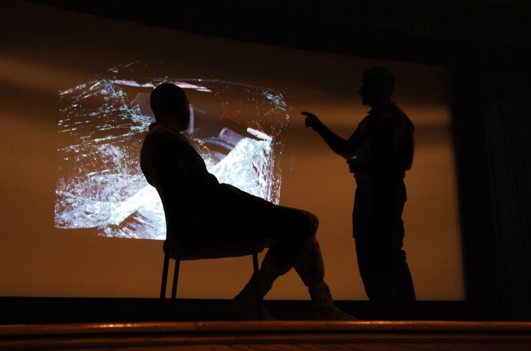 Paramedic Vince Easevoli (right) explains the effects of an alcohol-related car crash to Senior Airman Braxton Ward, 480thtIntellligence, Surveillance and Reconnaissance Wing Knowledge operations specialist (left) during the Street Smart presentation at the Langley Air Force Base, Va. theater, Nov. 8, 2012.  Street Smart is an interactive safety briefing that covers a range of driving-related subjects including seatbelt usage, driver distractions, driving under the influence and driving recklessly. (U.S. Air Force photo by Staff Sgt. Katie G. Ward/Released)