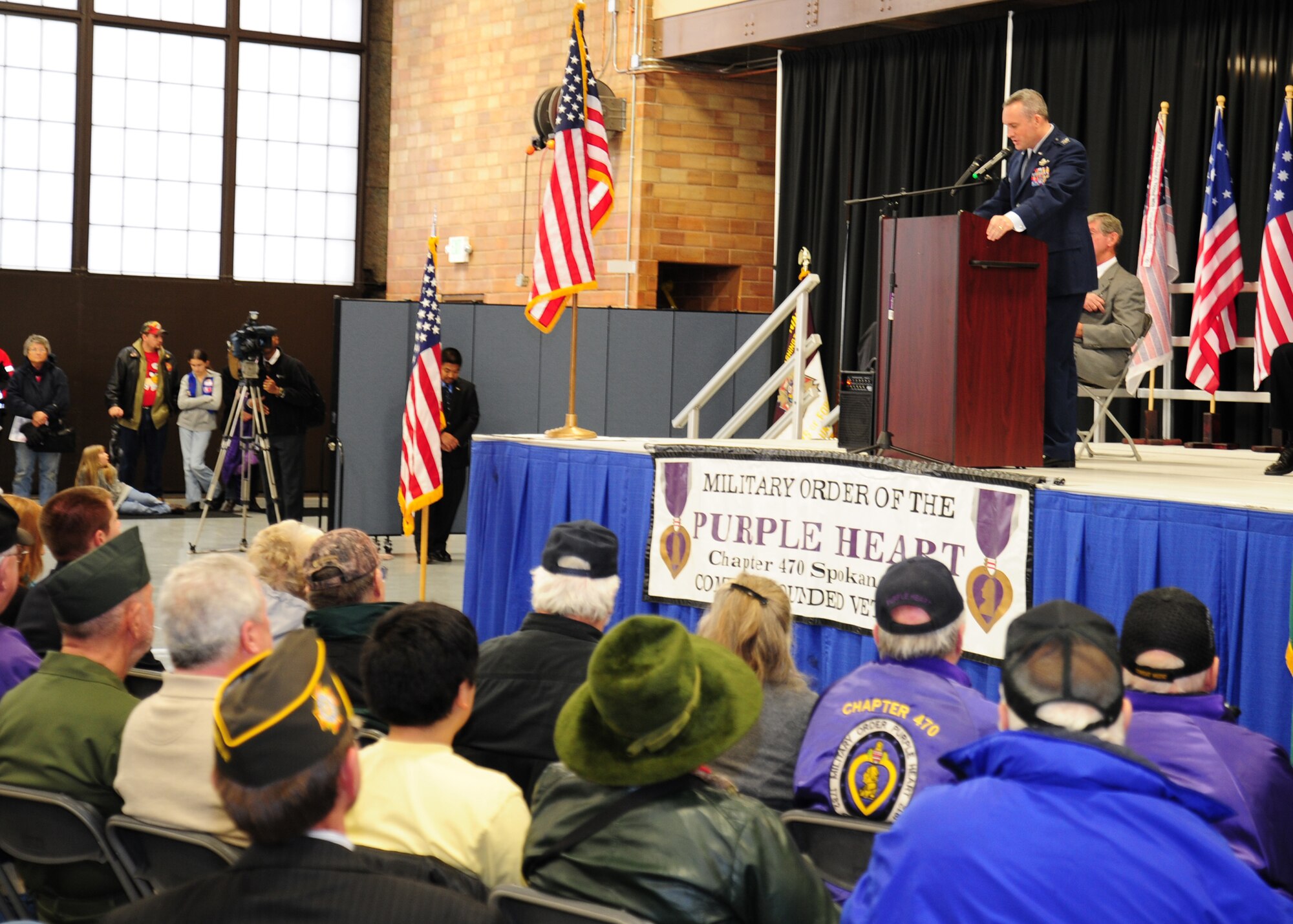 Col. Brian Newberry, 92nd Air Refueling Wing commander, speaks to a standing room only crowd during the Veterans Day ceremony at Felts Field in Spokane, Wash., Nov. 12, 2012. During his speech Newberry proudly saluted veterans past and present, as well as the community that supports the men and women in uniform. (U.S. Air Force photo by Tech. Sgt. Henry Hoegen)