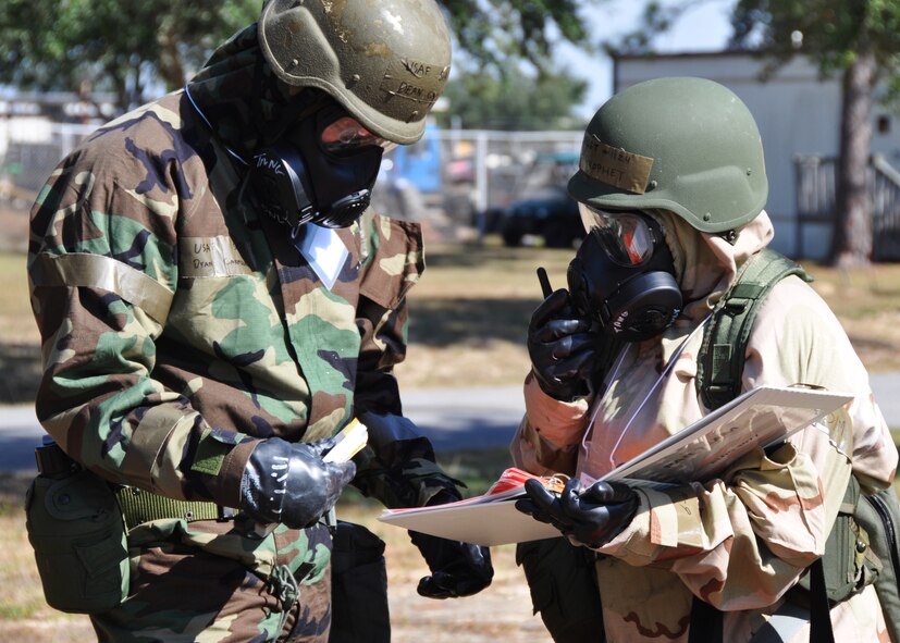 Senior Airman Dean Carmichael, left, and Master Sgt. Tiffany Prophet of the 919th Special Operations Wing staff relay post-attack information during a recent chemical warfare exercise at Duke Field, Fla.   The exercise helped the Air Force reservists hone their combat readiness skills for worldwide deployment. (U.S. Air Force photo/Dan Neely)