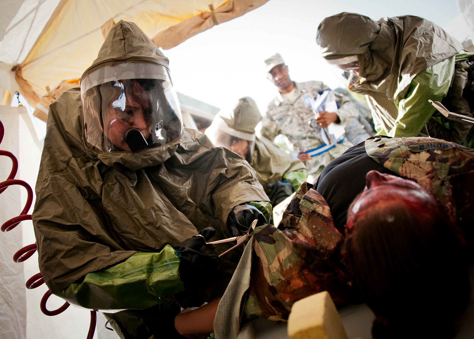A member of the 96th Medical Group removes contaminated clothing from a bomb blast victim during the group’s radiological response exercise Nov. 7 at Eglin Air Force Base, Fla.  The goal of the exercise was to evaluate the base’s response to a terrorist bombing and the group’s reaction to a chemical, biological, radiological, nuclear and explosive (CBRNE) incident.  (U.S. Air Force photo/Samuel King Jr.)