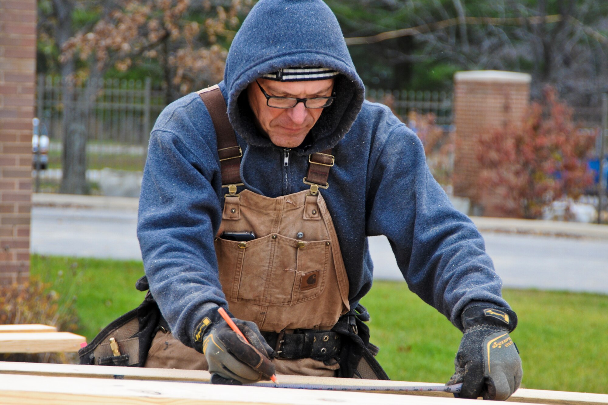 YOUNGSTOWN AIR RESERVE STATION, Ohio — Mr. Mark Hannan, senior carpenter, measures the gable end of the roof of the visitor center here, Nov. 13, 2012. Hannan and the other contractors are prepping the roof area for the trusses that will be hoisted into place by a crane tomorrow.  Released/U.S. Air Force photo by Tech. Sgt. Brenda Cosola