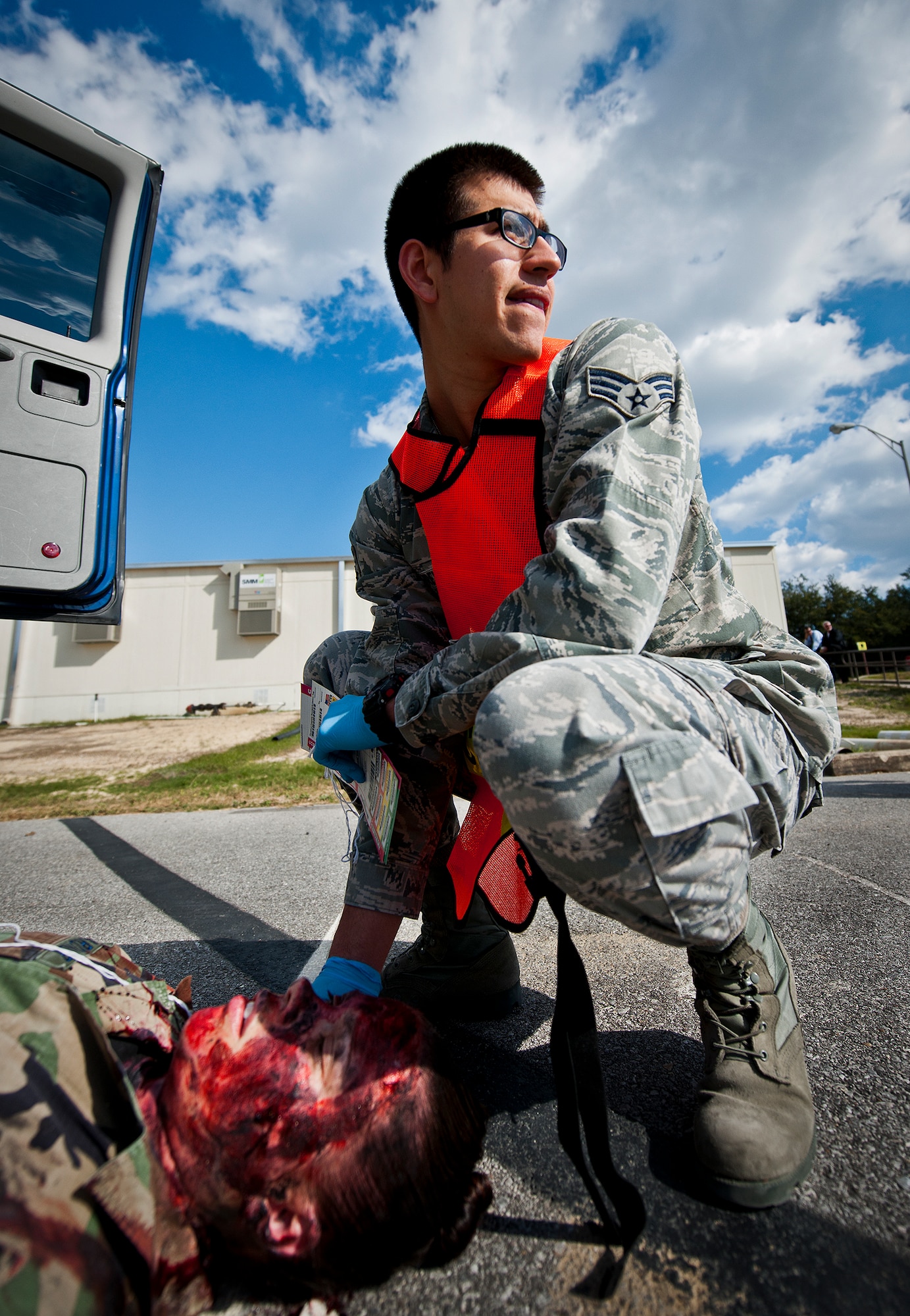 Senior Airman Alfred Trevino, of the 96th Medical Group, waits with a simulated victim for more help to arrive during the group’s radiological response exercise Nov. 7 at Eglin Air Force Base, Fla.  The goal of the exercise was to evaluate the base’s response to a terrorist bombing and the group’s reaction to a chemical, biological, radiological, nuclear and explosive (CBRNE) incident.  (U.S. Air Force photo/Samuel King Jr.)