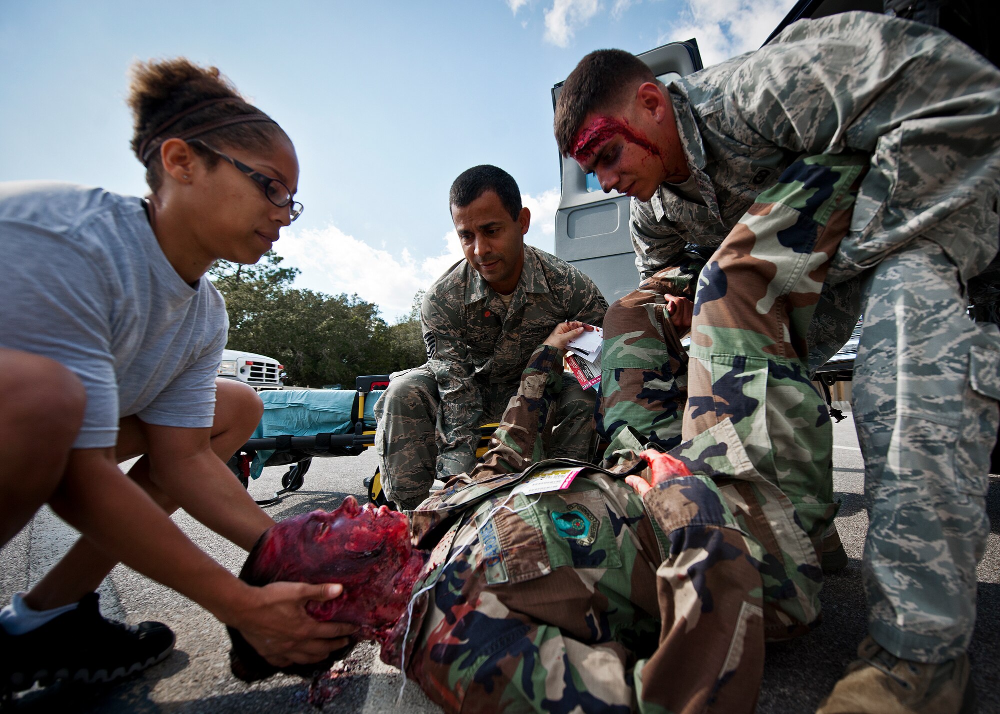 Tech. Sgt. Andrew Salas, of the 96th Medical Group, and others move a simulated victim to a stretcher during the group’s radiological response exercise Nov. 7 at Eglin Air Force Base, Fla.  The goal of the exercise was to evaluate the base’s response to a terrorist bombing and the group’s reaction to a chemical, biological, radiological, nuclear and explosive (CBRNE) incident.  (U.S. Air Force photo/Samuel King Jr.)