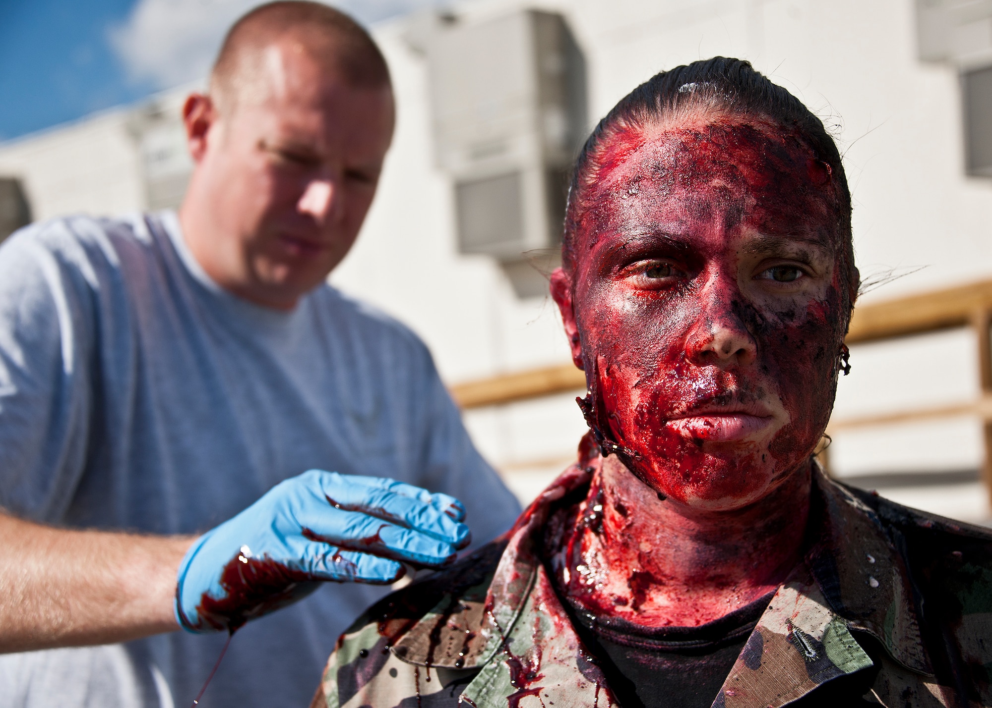 A 96th Medical Group moulage team member puts the finishing touches on a simulated blast victim prior to the group’s radiological response exercise Nov. 7 at Eglin Air Force Base, Fla.  The goal of the exercise was to evaluate the base’s response to a terrorist bombing and the group’s reaction to a chemical, biological, radiological, nuclear and explosive (CBRNE) incident.  (U.S. Air Force photo/Samuel King Jr.)