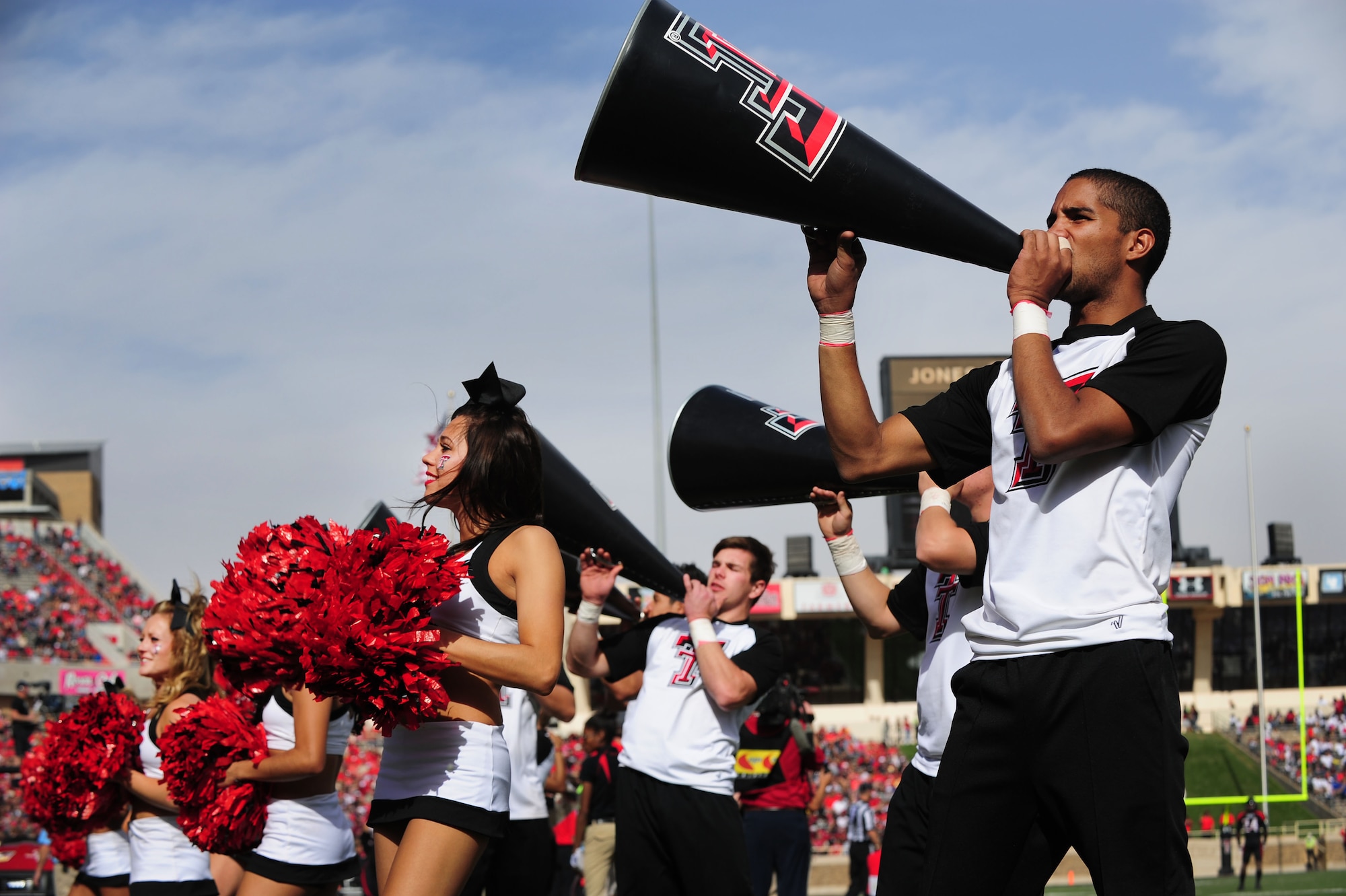 Cheerleaders pump up stadium spectators during a football game at Texas Tech University in Lubbock, Texas, Nov. 10, 2012. All branches of service were invited to attend a free football game as the Texas Tech Red Raiders took on the University of Kansas Jayhawks for Military Appreciation Day. (U.S. Air Force photo/Airman 1st Class Ericka Engblom) 