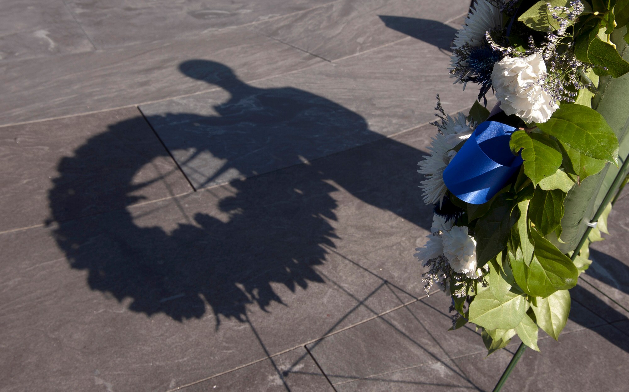 Airman 1st Brian O'Conner, from the Air Force Honor Guard, creates a shadow on the ground as he stands ready to assist during a wreath laying ceremony at the Air Force Memorial in observance of Veterans Day on Nov. 11, 2012, in Arlington, Va.  The ceremony was co-hosted by the Air Force Association and Air Force Sergeants Association; Secretary of the Air Force Michael Donley and Air Force Vice Chief of Staff Larry O. Spencer attended.   (U.S. Air Force photo/Andy Morataya)