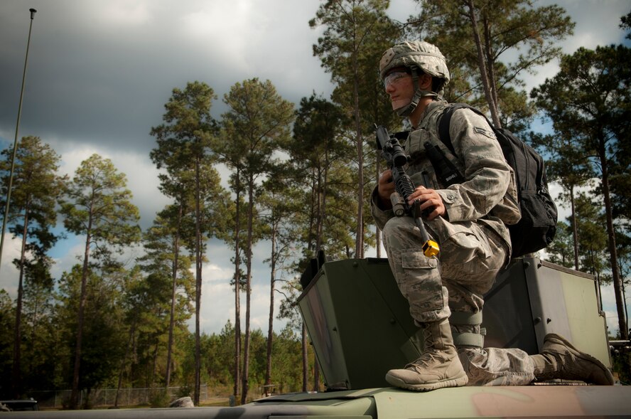 U.S. Air Force Airman 1st Class Stephen Zimmerman, 823d Base Defense Squadron Charlie flight fireteam member, crouches on a mine-resistant ambush-protected vehicle during a field training exercise at Moody Air Force Base, Ga., Nov. 7, 2012. The exercise lasted three days and consisted of day and night operation scenarios. (U.S. Air Force photo by Airman 1st Class Paul Francis/Released)
