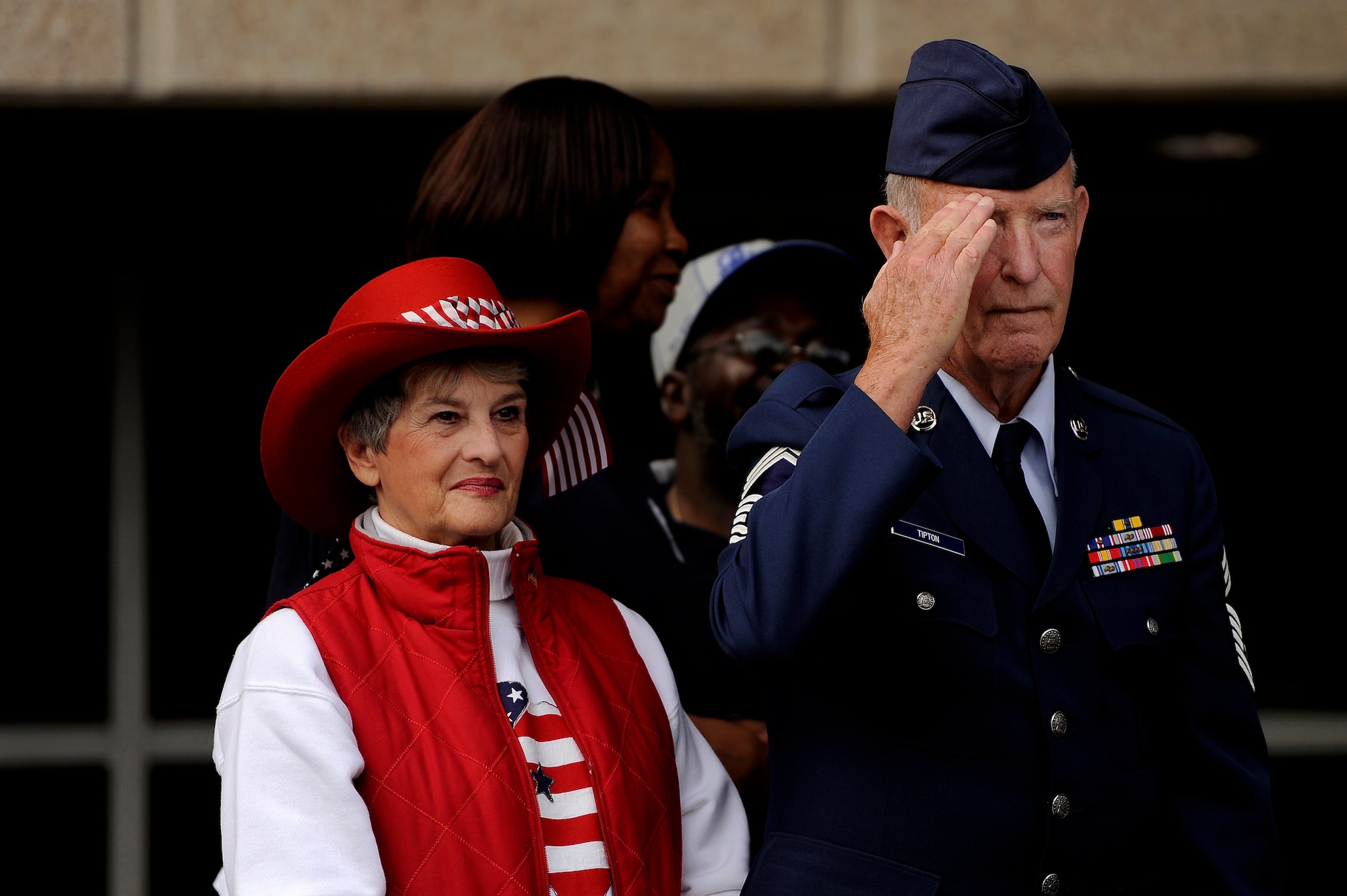 U.S. Air Force retired Chief Master Sgt. Stephen Tipton stands with his wife at his side while saluting Vietnam War veterans as they march past during a Veterans Day Parade, Nov. 12, 2012, Columbia, S.C. The parade, which took place on Sumter Street in the middle of downtown, saw numerous veterans like Tipton, as well as active-duty military personnel to include Airmen from Shaw Air Force Base in attendance. The event was Columbia’s 34th annual Veterans Day Parade. (U.S. Air Force photo by Staff Sgt. Kenny Holston/Released) 