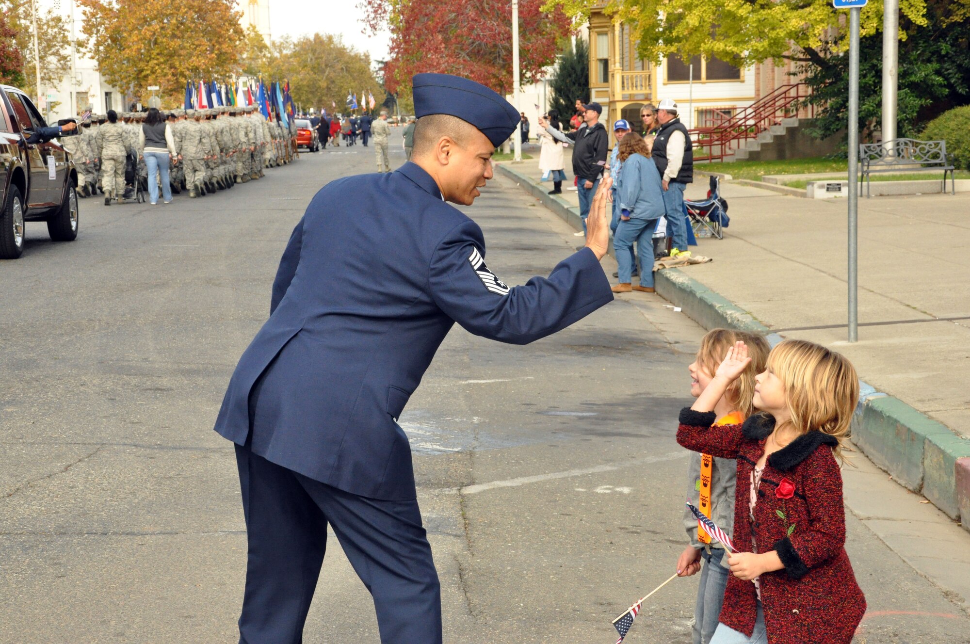 Command Chief Master Sergeant Jason Henderson, Command Chief 940th Wing Beale Air Force Base Calif. high fives a young attendee of the10th annual Yuba-Sutter Veterans Day Parade Nov. 11. Chief Henderson along with Col. Cavanagh led the formation of 940th wing members through the streets of downtown Marysville Calif. (U.S. Air Force Photo/Capt. Joe Simms)