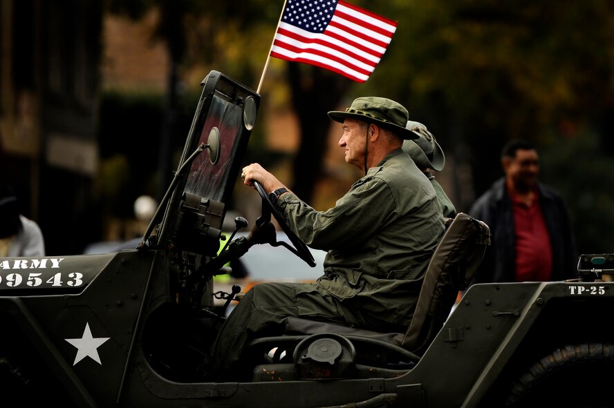 A young girl stares out the window of a U.S. Army Humvee as she rides along with her father in a Veterans Day Parade, Nov. 12, 2012, Columbia, S.C. The parade, which took place on Sumter Street in the middle of downtown, saw hundreds of civilians, veterans, and active-duty military personnel, to include Airmen from Shaw Air Force Base, in attendance. The event was Columbia’s 34th annual Veterans Day Parade. (U.S. Air Force photo by Staff Sgt. Kenny Holston/Released) 