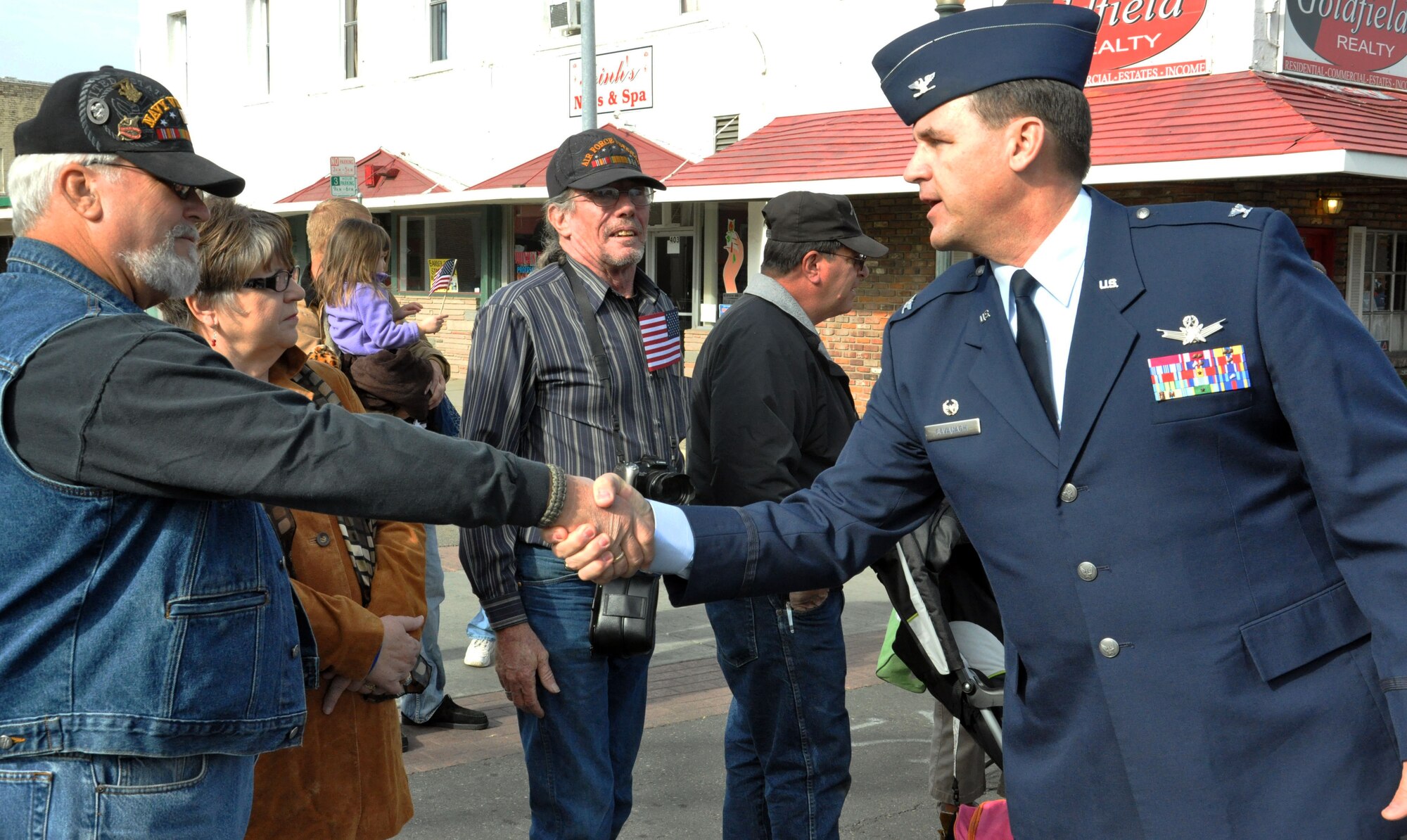 Colonel Kevin Cavanagh, Commander 940th Wing, Beale Air Force Base Calif. greets a Vietnam Veteran during the Vetarans Day Parade in downtown Marysville Nov. 11. Col. Cavanagh led the formation of reservists on the parade route while shaking hands and greeting those in attendance. (U.S. Air Force Photo/Capt. Joe Simms)