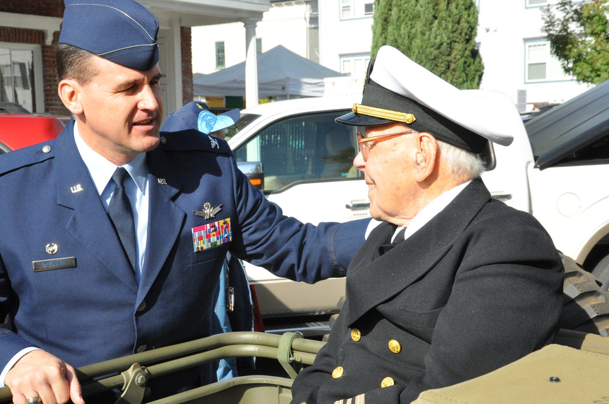 Colonel Kevin Cavanagh, Commander 940th Wing, shakes hands with Retired Lieutenant Commander Joe Landell during the Yuba-Sutter Veterans Day Parade Nov. 11. Lt Commader Landell is a Yuba City resident and survivor of the attack on Pearl Harbor in 1941. (U.S. Air Force Photo/Capt. Joe Simms)