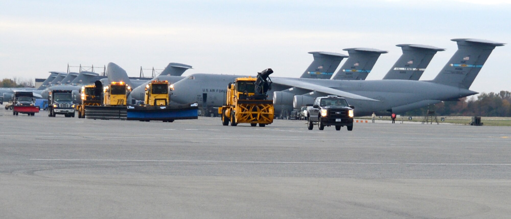Snow removal vehicles from the 436th Civil Engineer Squadron drive across the flightline during the annual Snow Parade Nov. 6, 2012, at Dover Air Force Base, Del. The Snow Parade allowed commanders the opportunity to learn about snow removal vehicles. (U.S. Air Force photo by Tech. Sgt. Chuck Walker)
