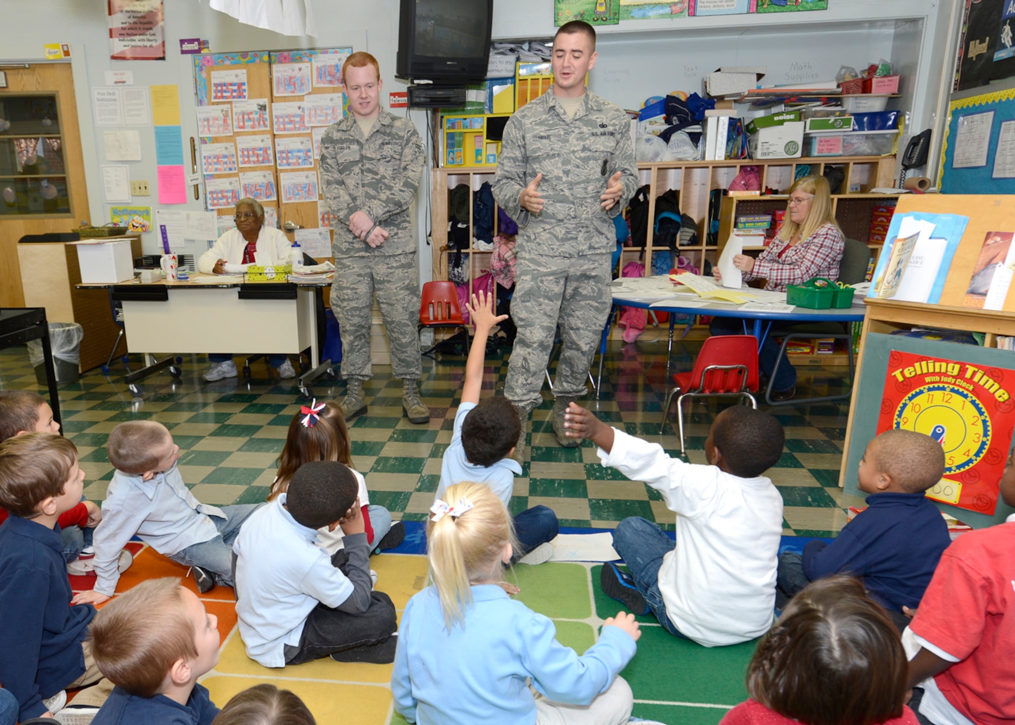 Staff Sgt. Thomas Faivre, 436th Security Forces Squadron, answers questions from students as Airman 1st Class Benjamin Fugler, 436th Maintenance Squadron looks on Nov. 9, 2012, at Lake Forest Elementary School in Felton, Del. Team Dover members spoke to students about their jobs and the military as part of a Veteran’s Day celebration hosted by the school. (U.S. Air Force photo by Tech. Sgt. Chuck Walker)