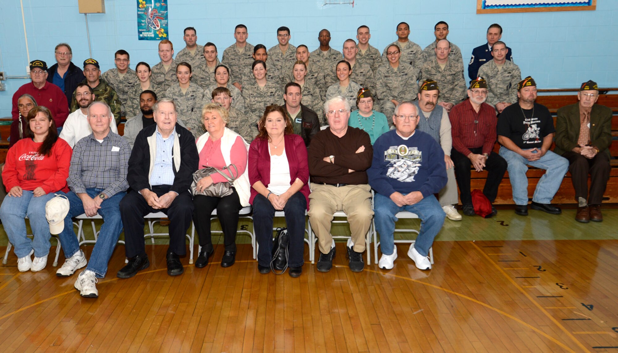 Active duty service members and veterans pose together following a Veteran’s Day celebration Nov. 9, 2012, at Lake Forest North Elementary School in Felton, Del. Members from Dover Air Force Base, Del., also spoke to the students about military service. (U.S. Air Force photo by Tech. Sgt. Chuck Walker)