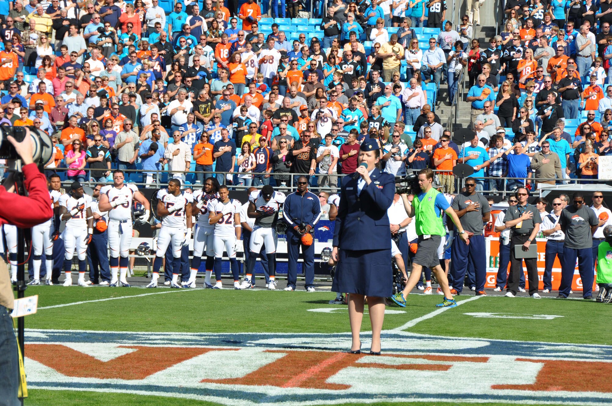 Maj. Erin Karl sings the national anthem at the Carolina Panthers Salute to Service game on Nov. 11, 2012 at the Bank of America Stadium in Charlotte, N.C. Karl is the deputy chief of public affairs with the 916th Air Refueling Wing, Air Force Reserve. (USAF photo by Maj. Shannon Mann, 916ARW/PA)
