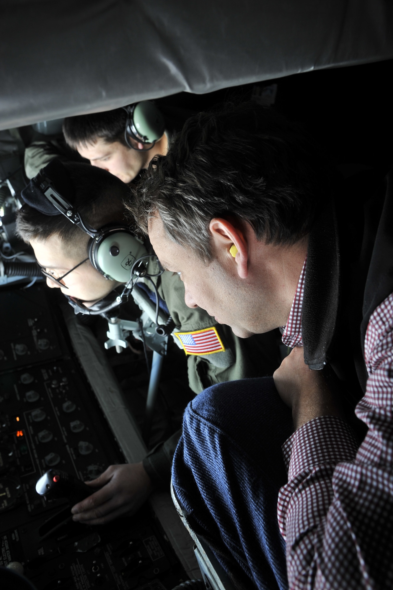 Spokane Mayor David Condon watches on as Airman 1st Class Nathaneal Bussey, a 92nd Air Refueling Squadron boom operator refuels an F-15 Eagle from Kingsley Field Air National Guard Base, Oregon, during a refueling training mission Nov. 8, 2012. The mayor and his cabinet members got to experience the Fairchild Air Force Base mission first hand. (U.S. Air Force photo by Senior Airman Mary O'Dell)