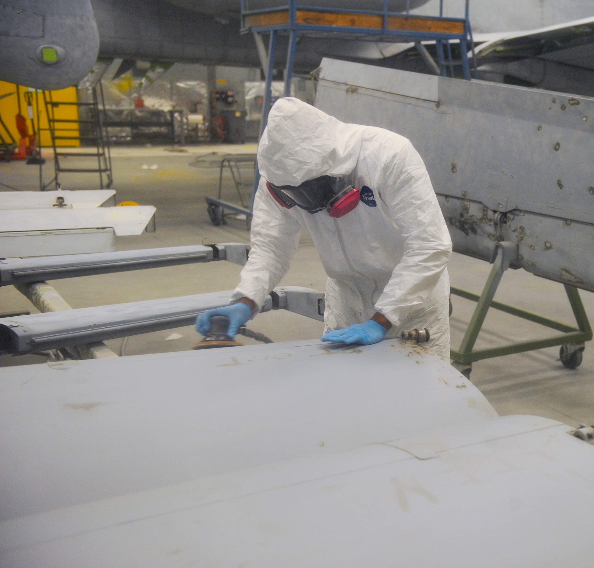 U.S. Air Force Senior Airman Jeremie Bumpers, 23d Equipment Maintenance Squadron aircraft structural maintenance journeyman, uses a sander to remove paint from an aircraft part at Moody Air Force Base, Ga., Nov. 7, 2012. Sanding the aircraft part makes it easier for the new coat of paint to be applied. (U.S. Air Force photo by Airman 1st Class Olivia Bumpers/ Released)