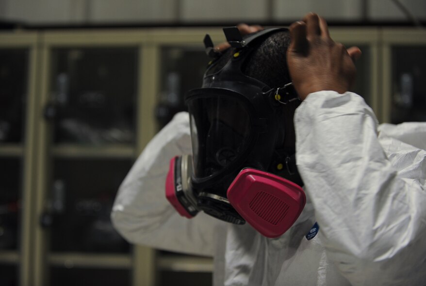 U.S. Air Force Senior Airman Jeremie Bumpers, 23d Equipment Maintenance Squadron aircraft structural maintenance journeyman, puts on his full-face air-purifying respirator at Moody Air Force Base, Ga., Nov. 7, 2012. The respirator is used to prevent breathing in hazardous materials. (U.S. Air Force photo by Airman 1st Class Olivia Bumpers/Released)