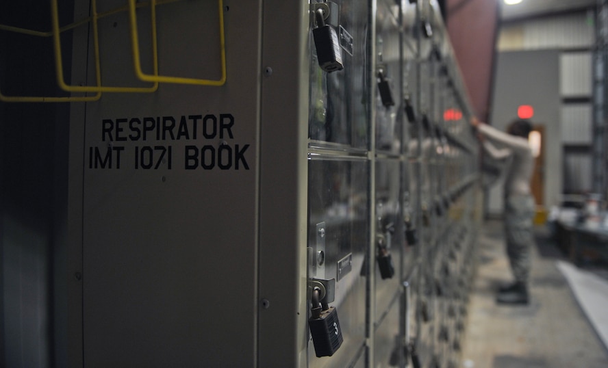 U.S. Air Force Senior Airman Jeremie Bumpers, 23d Equipment Maintenance Squadron aircraft structural maintenance journeyman, gets his full-face air-purifying respirator at Moody Air Force Base, Ga., Nov. 7, 2012. During any paint job, fabrication flight Airmen wear protective gear to prevent exposure to hazardous materials. (U.S. Air Force photo by Airman 1st Class Olivia Bumpers/Released)