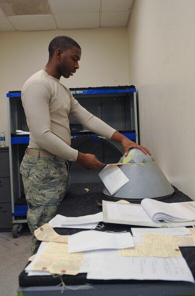 U.S. Air Force Senior Airman Jeremie Bumpers, 23d Equipment Maintenance Squadron aircraft structural maintenance journeyman, checks a tag on an aircraft part in the fabrication flight hangar at Moody Air Force Base, Ga., Nov. 7, 2012. The fabrication flight specializes in restoring paint on aircraft and aircrafts parts. (U.S. Air Force photo by Airman 1st Class Olivia Bumpers/Released)