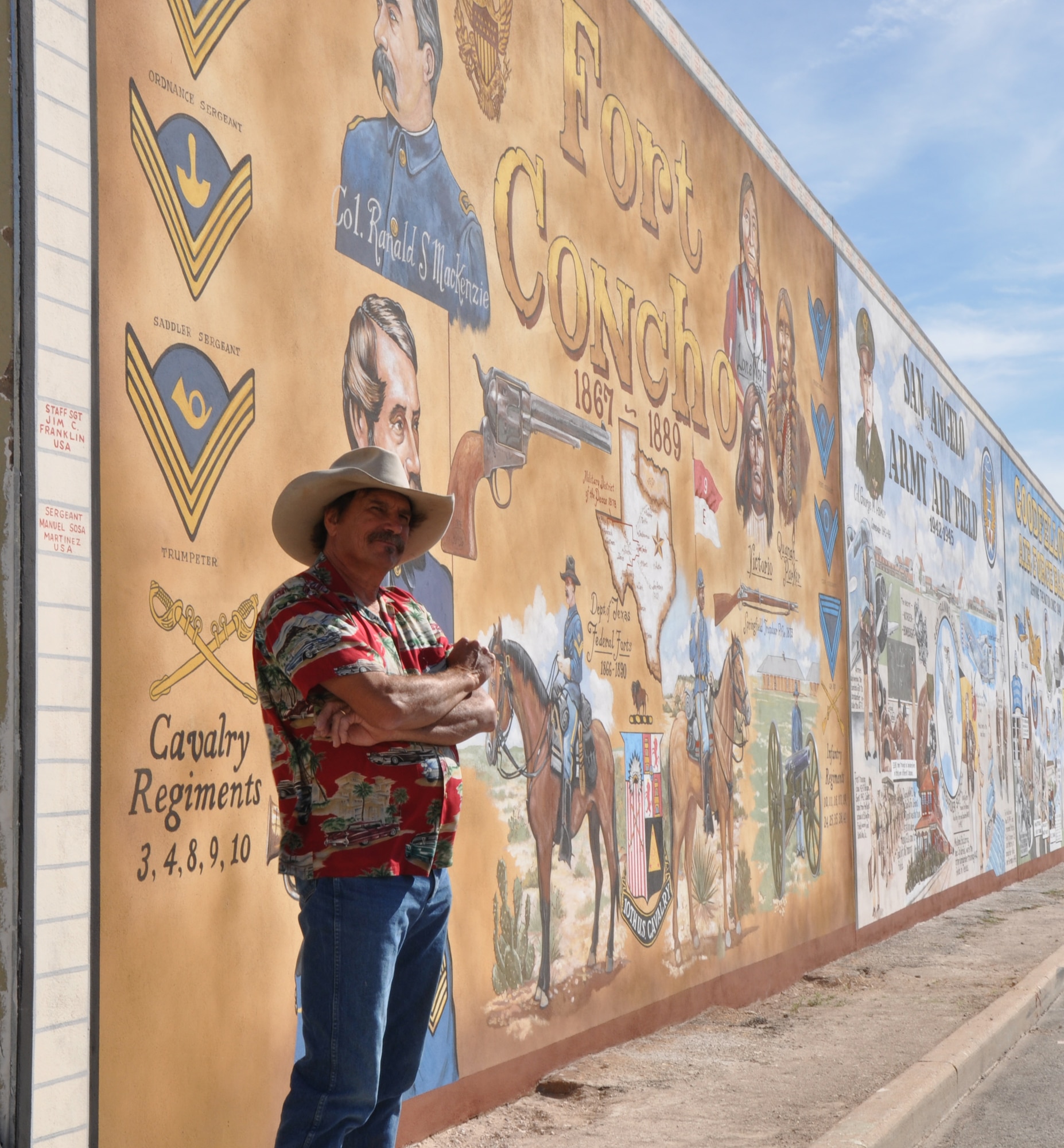 SAN ANGELO, Texas – Stylle Read, painter of the mural, stands in front of the mural in San Angelo Nov. 10. The mural was presented to the community after the Veterans’ Day Parade and shows the military history of San Angelo. (U.S. Air Force photo/ Airman 1st Class Joshua Edwards)