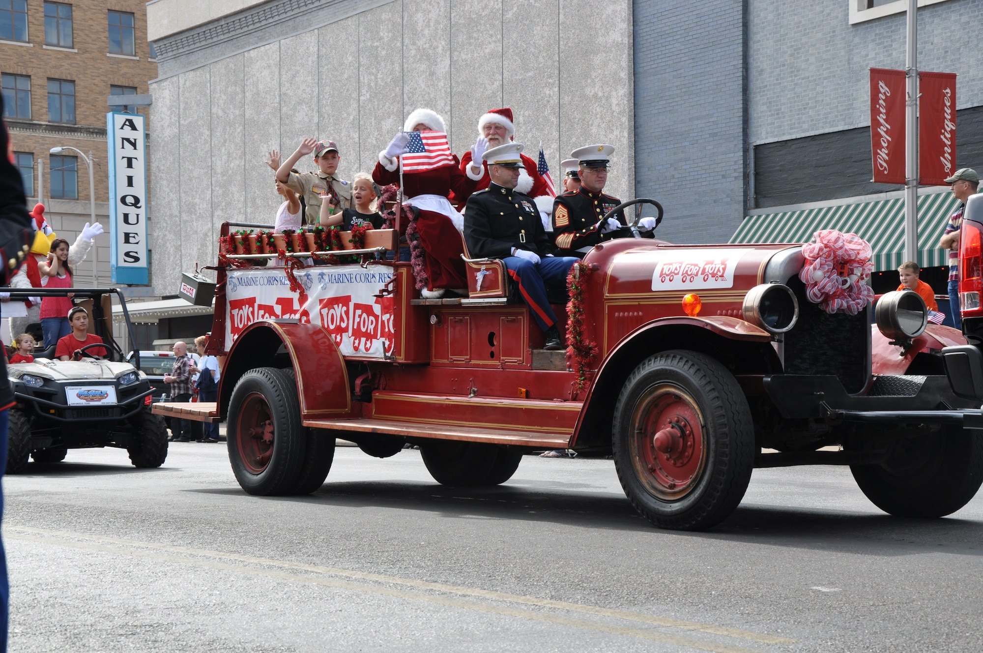 SAN ANGELO, Texas – Marines drive a truck with Santa in the back for Toys for Tots in the Veterans’ Day Parade in San Angelo Nov. 10. Marines also handed out candy canes to children along the parade route. (U.S. Air Force photo/ Airman 1st Class Joshua Edwards)