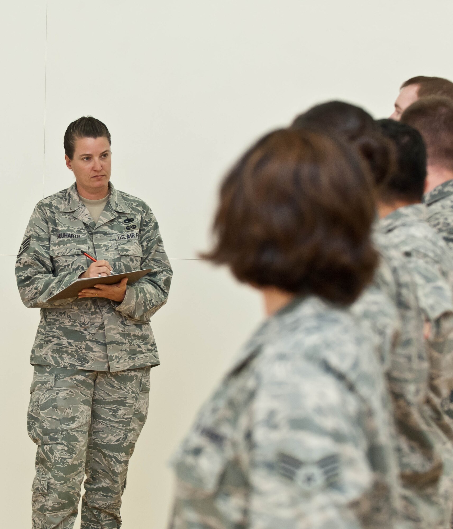 Staff Sgt. Deanna Neuharth, 28th Force Support Squadron Airman Leadership School instructor, evaluates Airmen on their drill performances during an inspection at Airman Leadership School on Ellsworth Air Force Base, S.D., Nov. 2, 2012. The Ellsworth ALS course curriculum recently underwent a 100 percent course rewrite, ensuring “Introduction to Negotiating” and “Resource Stewardship” were among the topics covered. (U.S. Air Force photo by Airman 1st Class Zachary Hada/Released)