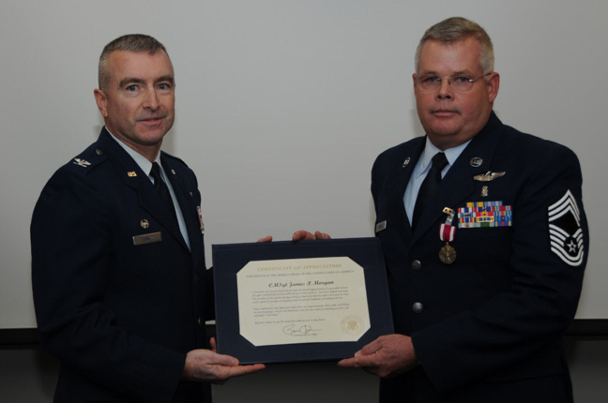 Col. Richard M. Cornell, 911 911th Airlift Wing, Aeromedical Staging Squadron commander,  presents a certificate of appreciation to Chief Master Sgt. James P. Morgan, ASTS chief of nursing services, for his honorable service, Nov. 3, 2012. Morgan, who started his career in the Air Force in 1979, got promoted to the rank of Chief Master Sergeant in 1993 and retired after 33 years of dedicated service to the Air Force and his country. (U.S. Air Force photo by Senior Airman Joshua J. Seybert/Released)