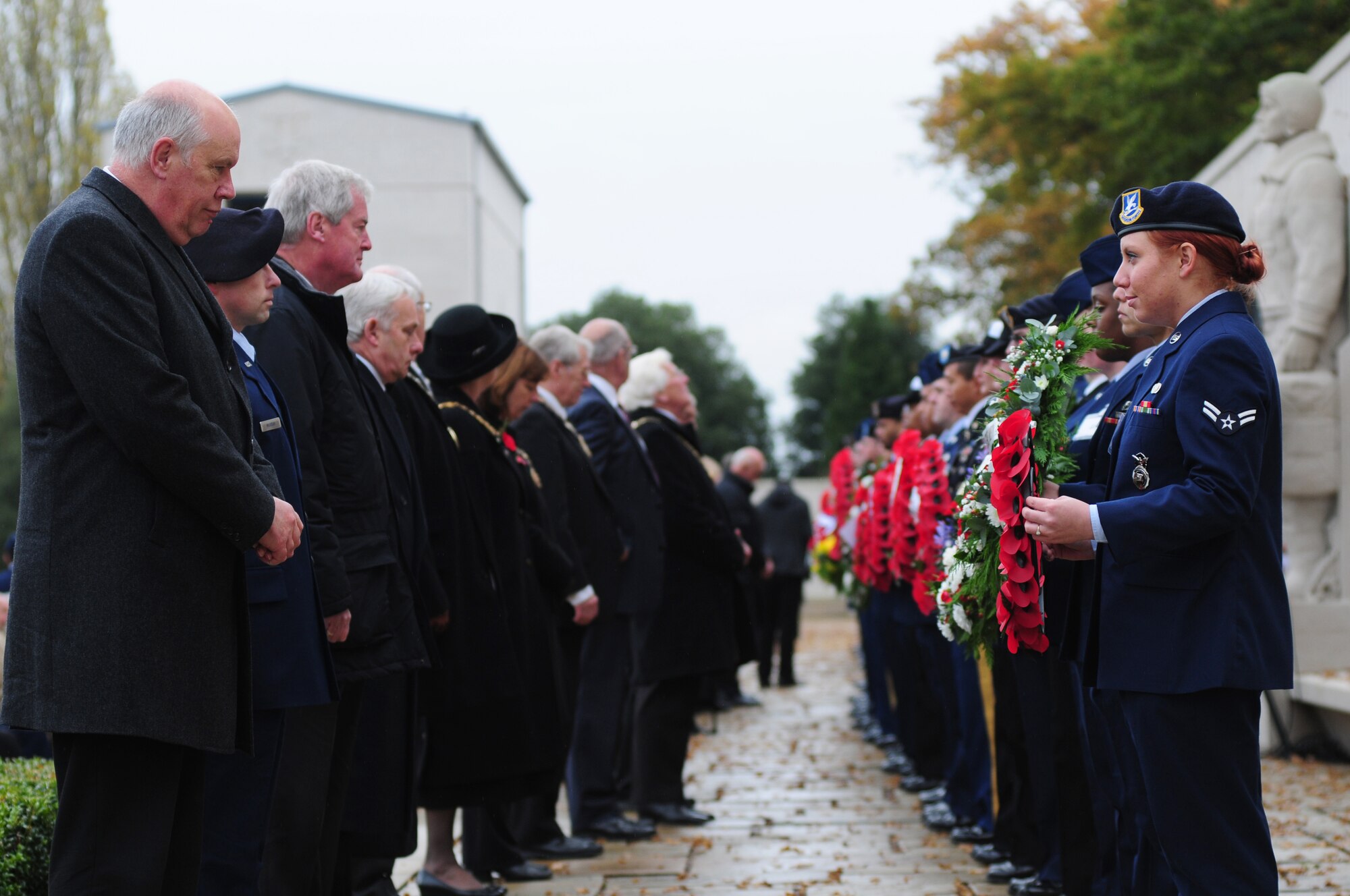CAMBRIDGE, England – U.S. service members from across the U.K. prepare to hand off wreaths to be laid at the Madingley American Cemetery Nov. 12, 2012. The annual Veterans Day ceremony was hosted by the 501st Combat Support Wing, RAF Alconbury, to honor and remember those who gave their lives in wars in Europe. (U.S. Air Force photo by Airman 1st Class Cory D. Payne)