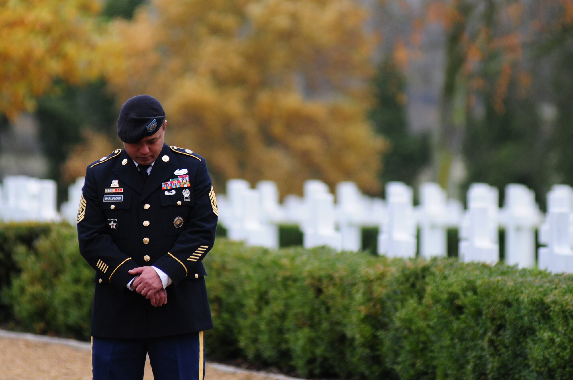 CAMBRIDGE, England – U.S. Army 1st Sgt. Louie Barlolong, RAF Molesworth Joint Intelligence Operations Center Europe analytic center commandant, stands during a moment of silence at Madingley American Cemetery Nov. 12, 2012. The annual Veterans Day ceremony was hosted by the 501st Combat Support Wing, RAF Alconbury, to honor and those who gave their lives in wars in Europe. (U.S. Air Force photo by Airman 1st Class Cory D. Payne)