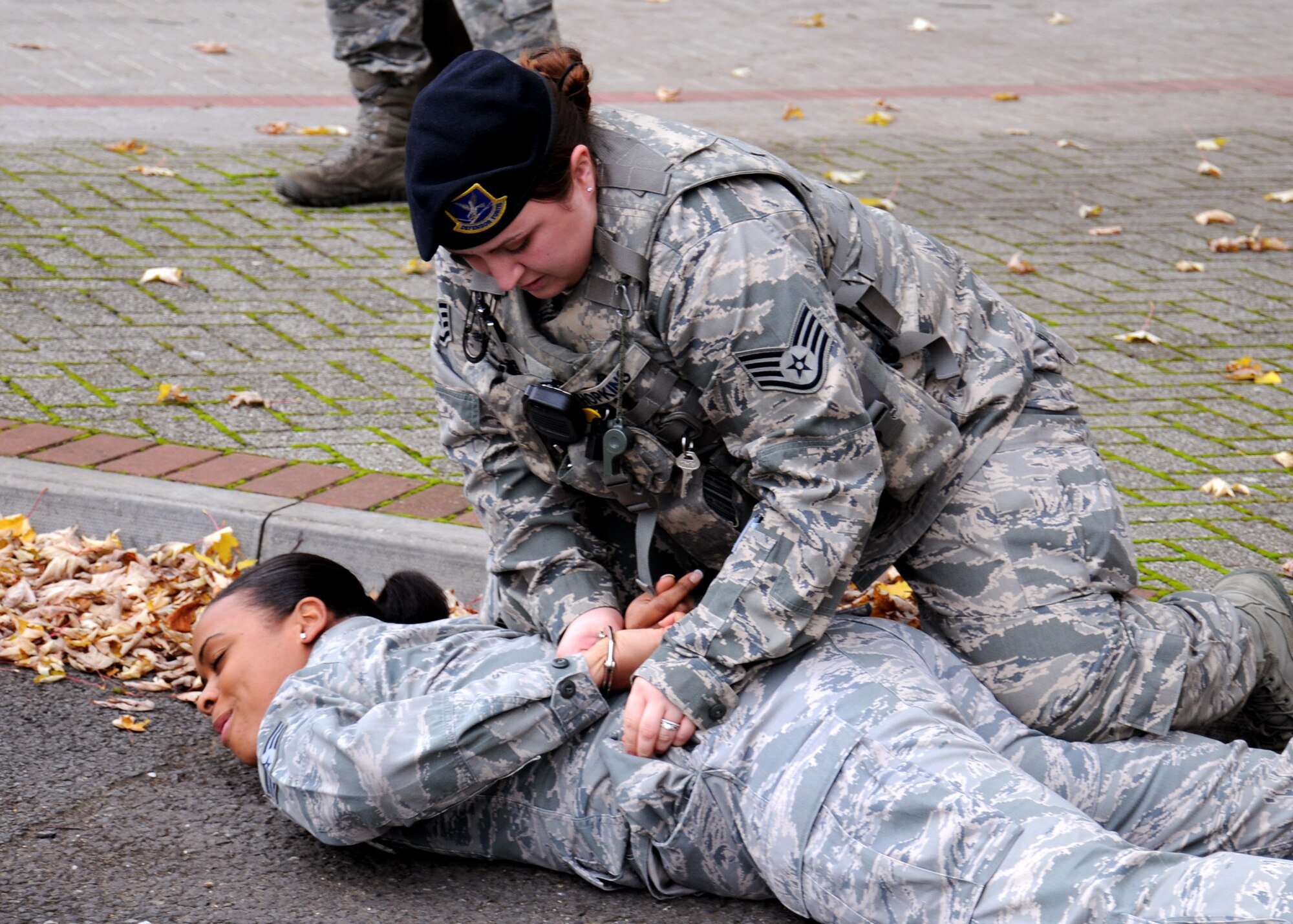 Staff. Sgt. Theresa Hopkins, 100th Security Forces Squadron patrolman, apprehends a simulated aggressor during a squadron exercise Nov. 9, 2012, at RAF MIldenhall, England. The exercise was part of the squadron's preparations for an upcoming inspection. (U.S. Air Force photo by Gina Randall/Released)