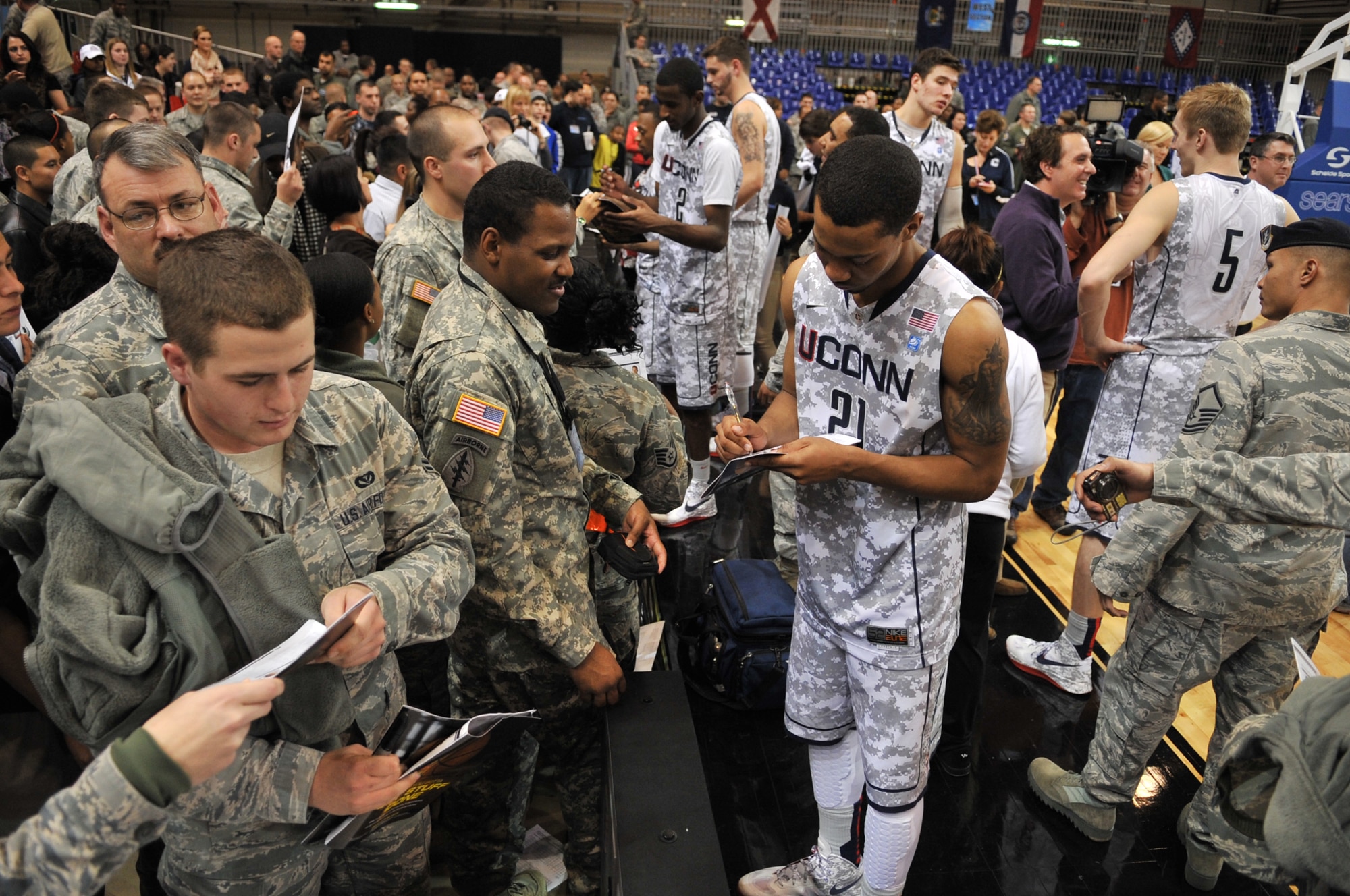 University of Connecticut players sign autographs for service members after the game against Michigan State during the Armed Forces Classic basketball game at Ramstein Air Base, Germany, Nov. 10, 2012.  Connecticut overcame Michigan 66-62. (U.S. Air Force photo/Master Sgt. Wayne Clark)