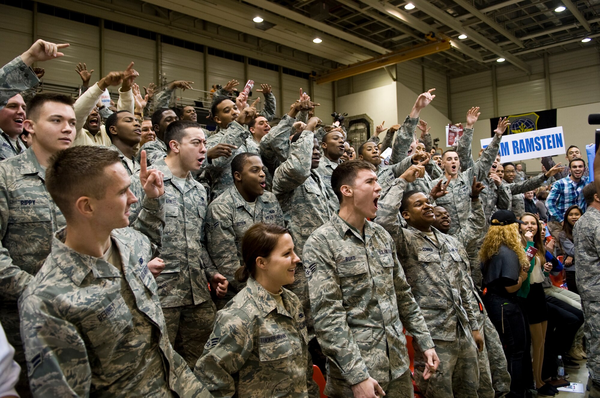 Airmen cheer for the ESPN camera during the Armed Forces Classic basketball game between the Michigan State Spartans and University of Connecticut Huskies at Ramstein Air Base, Germany, Nov. 10, 2012.  The Huskies overcame the Spartans 66-62. (U.S. Air Force photo/Master Sgt. Wayne Clark)