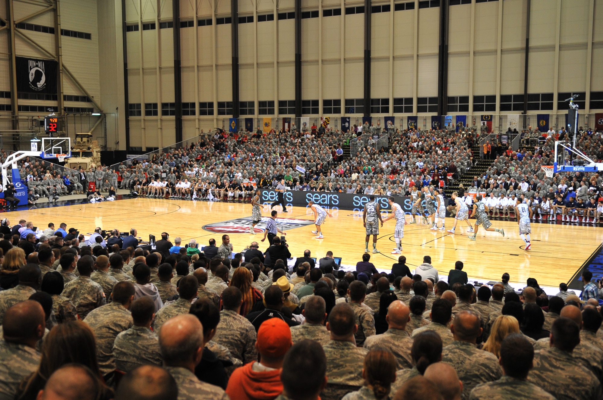 Service members watch the Armed Forces Classic basketball game between the Michigan State Spartans and University of Connecticut Huskies at Ramstein Air Base, Germany, Nov. 10, 2012.  The Huskies overcame the Spartans 66-62. (U.S. Air Force photo/Master Sgt. Wayne Clark)
