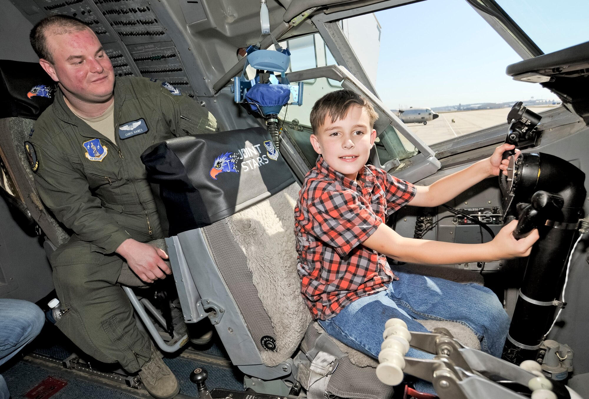 Josey Rackley learns about the E-8C Joint STARS aircraft from Capt. Christopher Hanes, 128th Airborne Command and Control Squadron, during the 116th and 461st Air Control wings annual Family Day celebration at Robins Air Force Base, Ga., Nov. 3, 2012. This marked the 10th annual Family Day for JSTARS.  The yearly event provides an opportunity to thank families for their support. (National Guard photo by Master Sgt. Roger Parsons/Released)