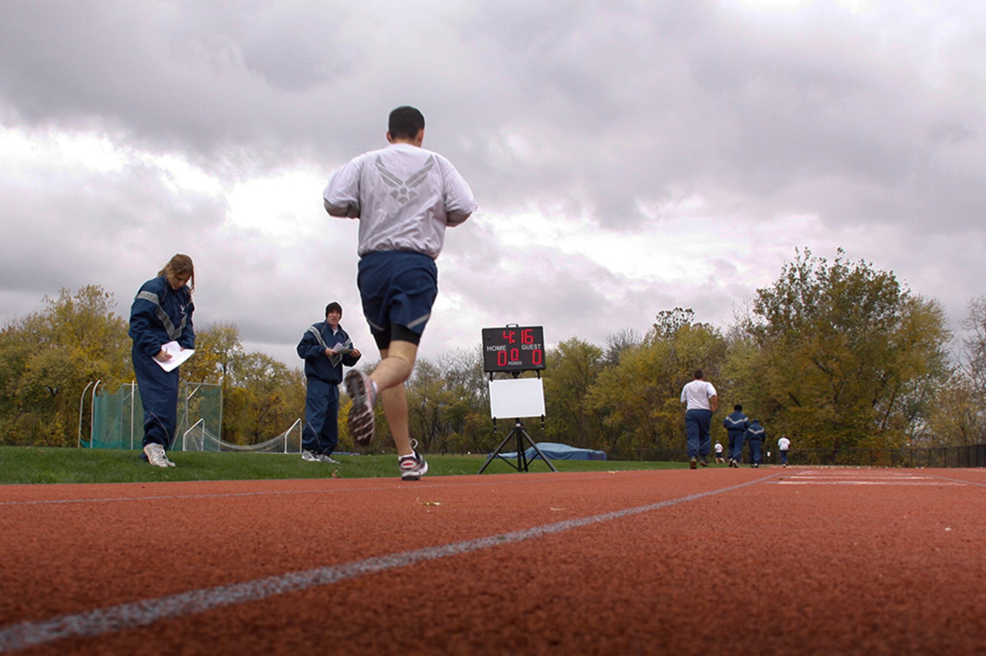 911th Airlift Wing personnel complete their 1.5 mile run during their Physical Training test held Nov. 3, 2012 at the Robert Morris University, Neville Island Sports Center in Coraopolis, Pa. Through a joint partnership with RMU and the Moon Twp. High School, unit members are authorized to use these facilities to meet their semi/annual physical fitness requirements.  The Air Force physical fitness test is comprised of a waist measurement, timed push-ups and sit-ups and concludes with a timed 1.5 mile run. Find out more about leading a healthy lifestyle by checking out the Wingman toolkit @ http://afrc.wingmantoolkit.org/  (U.S. Air Force photo by Senior Airman Justyne Obeldobel/Released)