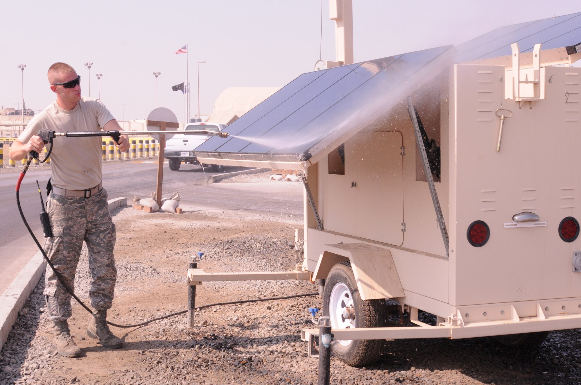 SOUTHWEST ASIA -- Senior Ryan Rhodes, 380th Expeditionary Civil Engineer Squadron power production technician, power washes the solar panels on a light cart Nov. 12, 2012. Rhodes, an Arlington, Wash., native, is deployed from Minot Air Force Base, N.D. (U.S. Air Force photo/Tech. Sgt. Amanda Savannah)