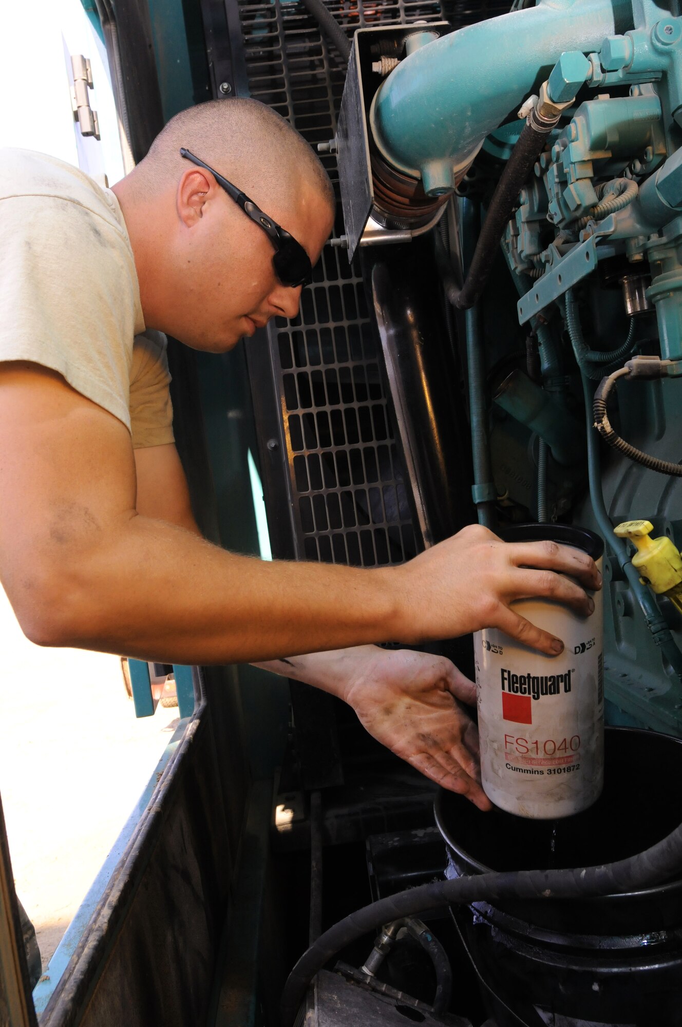 SOUTHWEST ASIA -- Senior Airman Matt Norman, 380th Expeditionary Civil Engineer Squadron power production technician, changes the oil on a lighting vault generator Nov. 12, 2012. Norman, an Augusta, Kan., native, is deployed from Langley Air Force Base, Va. (U.S. Air Force photo/Tech. Sgt. Amanda Savannah)