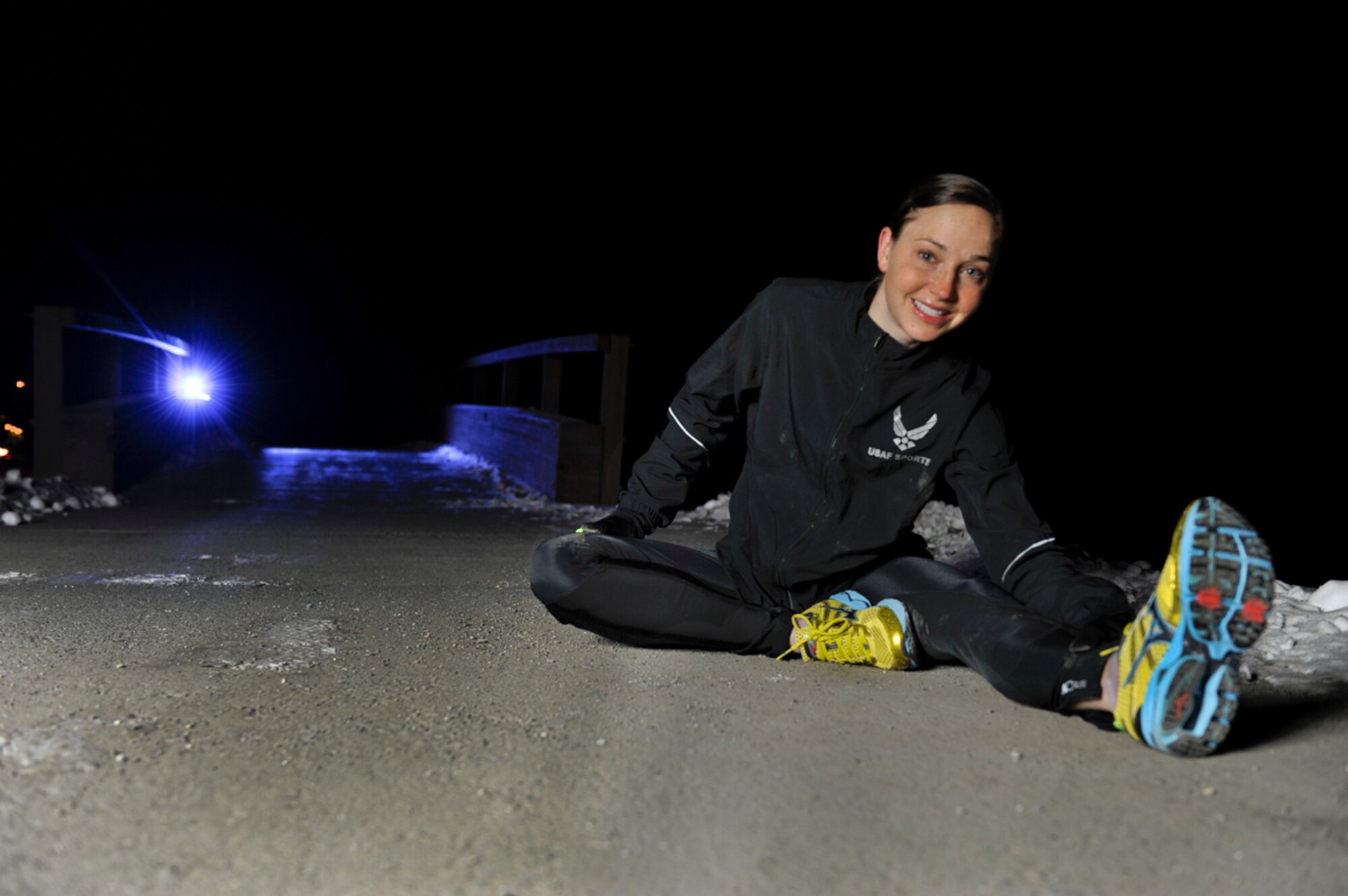 1st Lt. Caitlin Oviatt stretches after a morning run on Joint Base Elmendort-Richardson, Alaska, on Nov. 6, 2012. Oviatt is a marathon runner who, as part of a three-woman team, competed against every branch of service to win the All Service Championship for the Air Force female division at the 2012 Marine Corps Marathon, held in Washington, D.C. Oct. 28. (U.S. Air Force photo/Staff Sgt. Robert Barnett)
