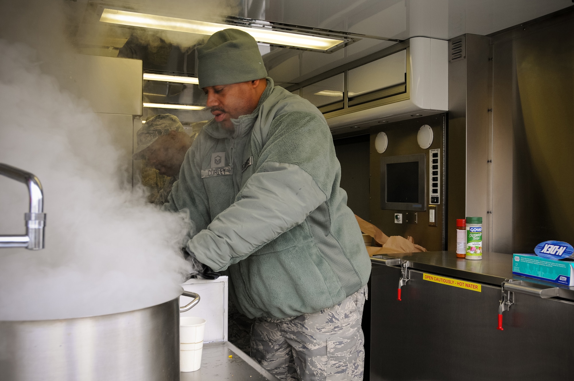 Master Sgt. Corey from the 113th Force Support Squadron prepares hot food during a new mobile field kitchen during a demonstration at Joint Base Andrews, Md., Nov. 3. The Disaster Relief Mobile Kitchen Trailer  can deploy to natural disaster sites to provide hot meals to relief workers and Airmen working in austere conditions. (U.S. Air force photo by Airman 1st Class Sumena Leslie/Released)