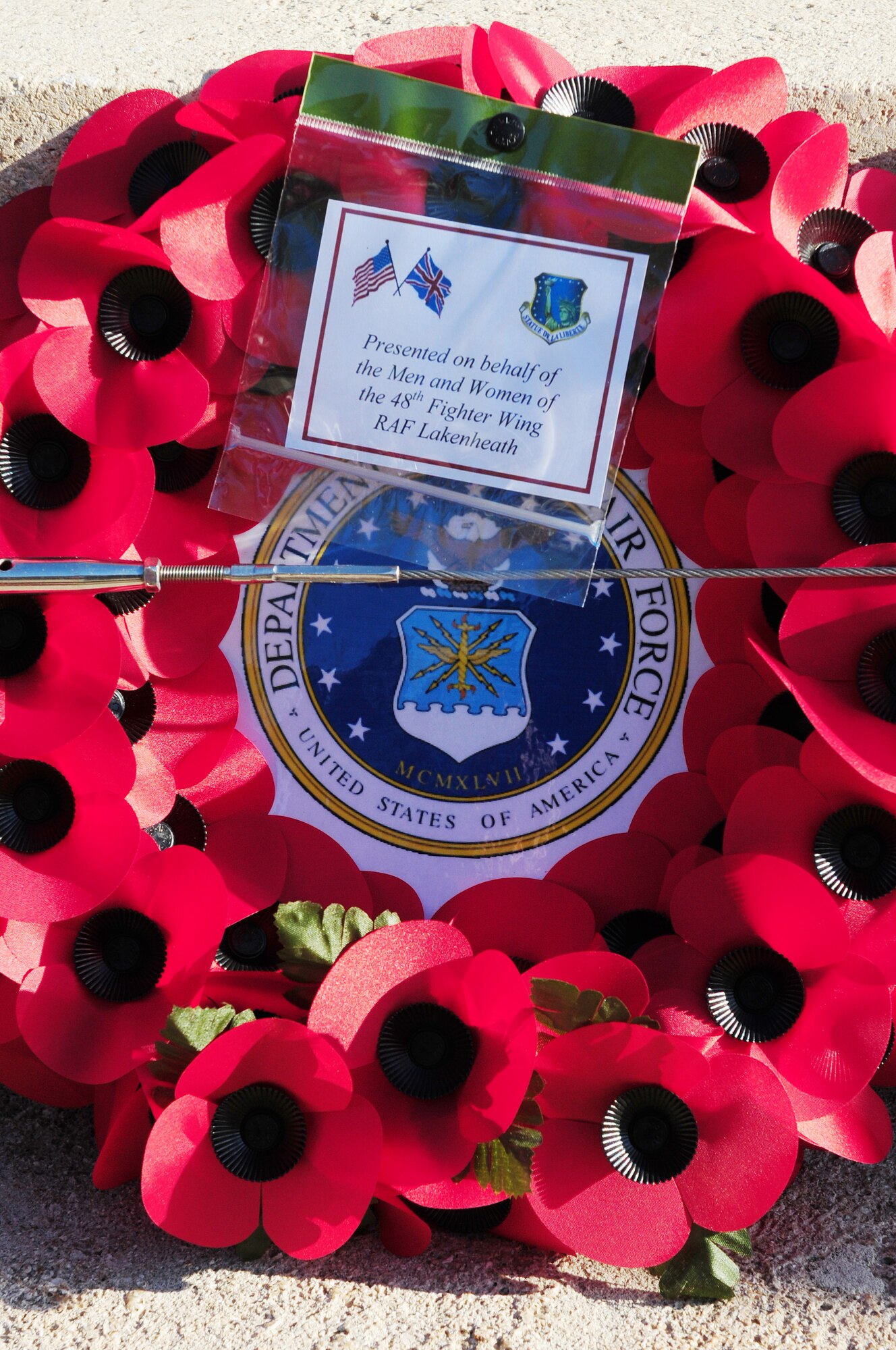 BURY ST. EDMUNDS, England -- A poppy wreath is presented by Col. Kyle Robinson, 48th Fighter Wing commander, on behalf of the men and women of the 48th FW during a Remembrance Day ceremony, Nov. 11, 2012. The annual ceremony is held in honor of those who have dedicated their lives in service to their country and made the ultimate sacrifice. (U.S. Air Force photo by Senior Airman Lausanne Morgan)