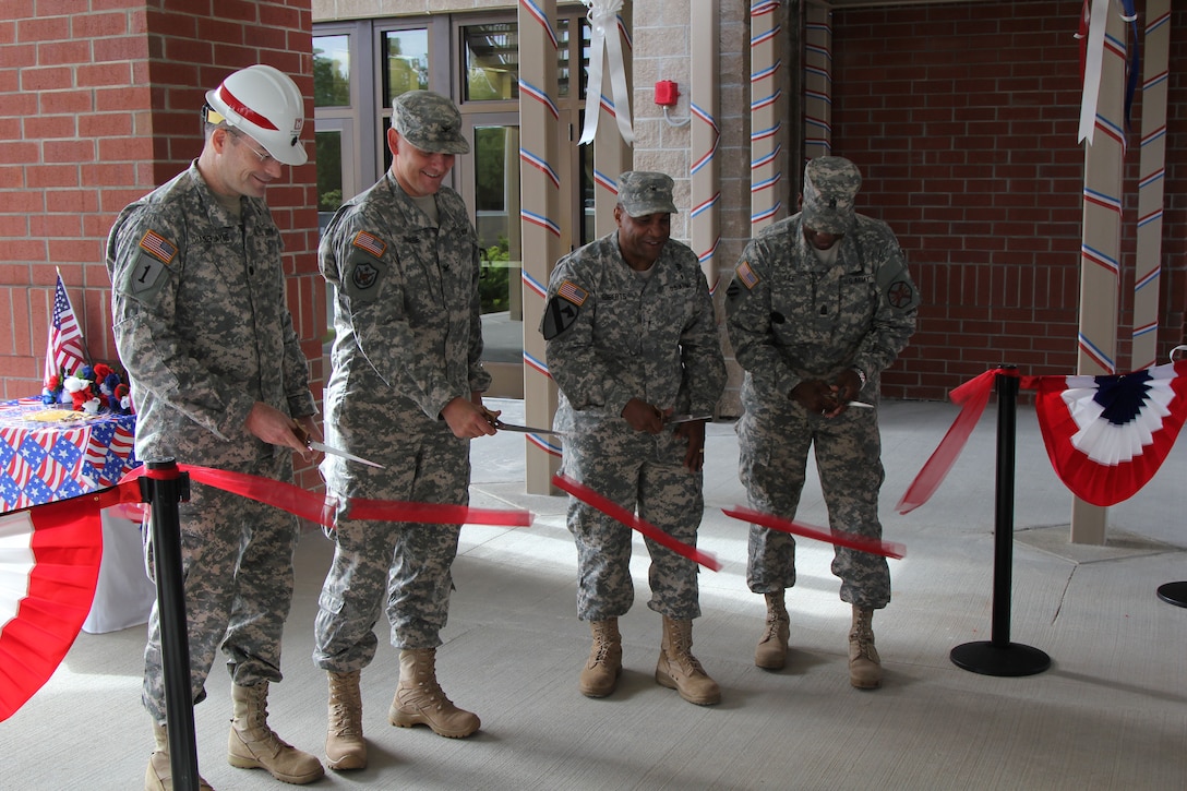 Lt. Col. Chamberlayne, Brig. Gen. Roberts and others cut the ribbon on the Quad DFAC.