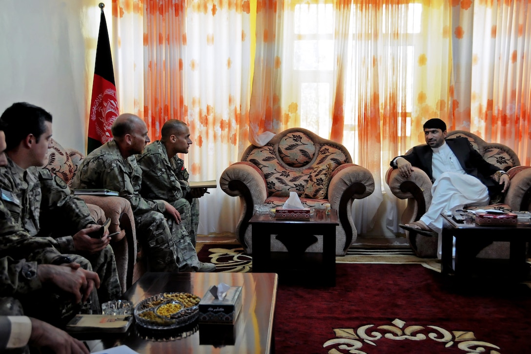 Dr. Mohammad Akram Khpalwak, right, governor of Afghanistan's Farah province, talks with U.S. Navy Cmdr. Louis McCray, left, and others during a key leaders meeting in Farah City, Afghanistan, Nov. 12, 2012. McCray commands Provincial Reconstruction Team Farah.