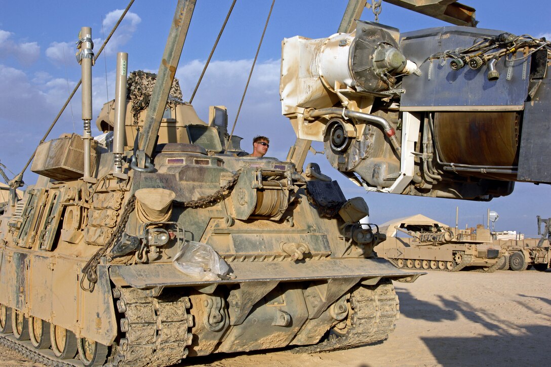 U.S. Marine Corps Lance Cpl. Joe Shilen operates an M88A2 Hercules armored recovery vehicle to lift the engine into an M1A1 Abrams tank on Combat Outpost Shir Gazay in Afghanistan's Helmand province, Nov. 4, 2012. Shilen, a mechanic, is assigned to Bravo Company, 2nd Tank Battalion.