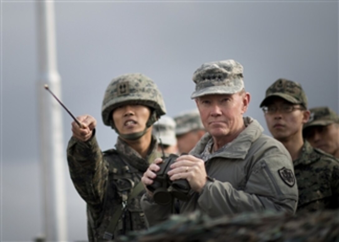 A South Korean soldier, left, briefs Chairman of the Joint Chiefs of Staff Gen. Martin E. Dempsey on points of interest at the Demilitarized Zone separating North and South Korea on Nov. 11, 2012.  