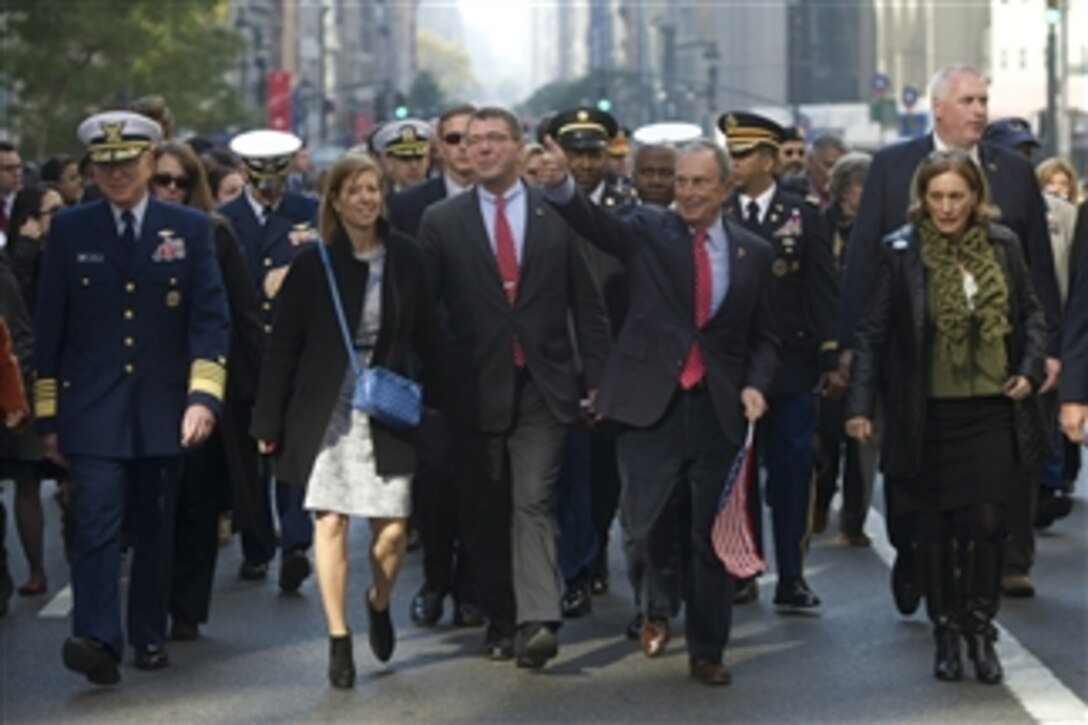 Deputy Secretary of Defense Ashton B. Carter, center, and his wife Stephanie, second from left, are joined by Commandant of the Coast Guard Adm. Robert J. Papa, Jr., left, and New York City Mayor Michael Bloomberg, second from right, as they walk down Fifth Avenue in the 2012 New York City Veterans Day Parade, on Nov. 11, 2012.  Carter was an honorary grand marshal for the parade.  