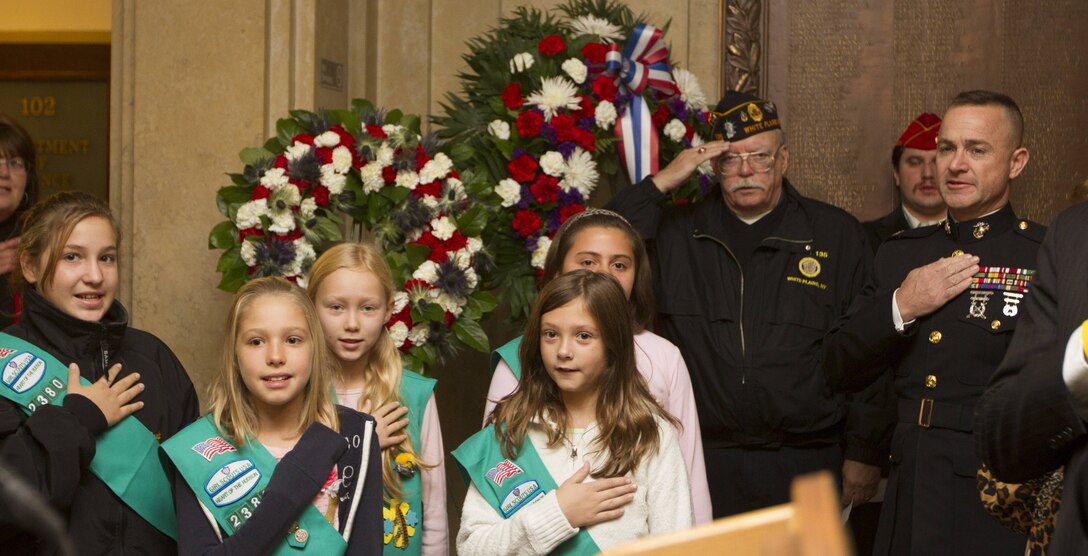Col. J. J. Dill, the commanding officer of the 1st Marine Corps District, says the Pledge of Allegiance surrounded by local Girl Scouts and veterans during the City of White Plains Veterans Day Ceremony at the White Plains City Hall.  Dill was the guest speaker at the ceremony, which was organized to recognize the sacrifices of the men and women who have served in the armed forces.